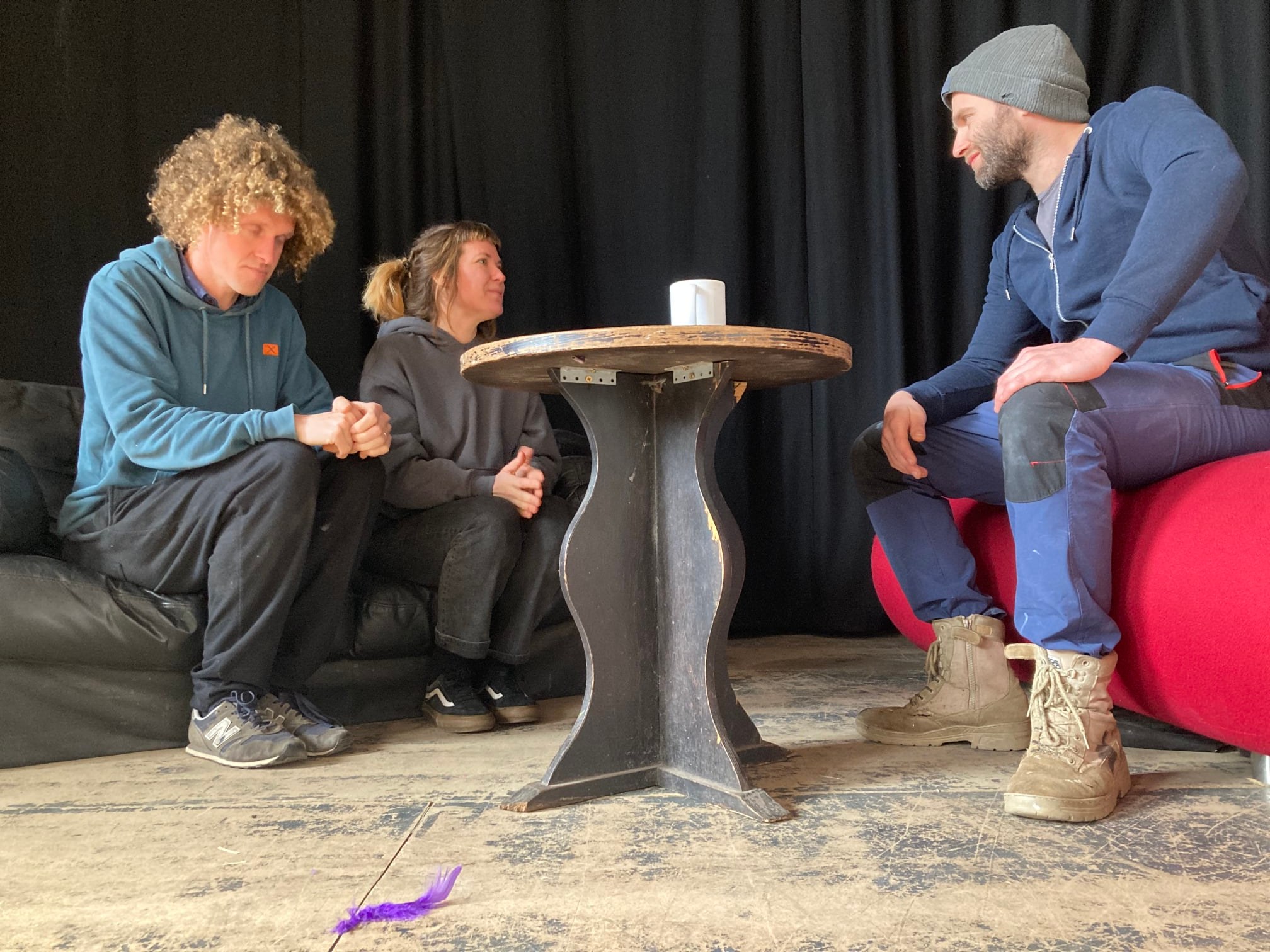 Three actors in performance setting